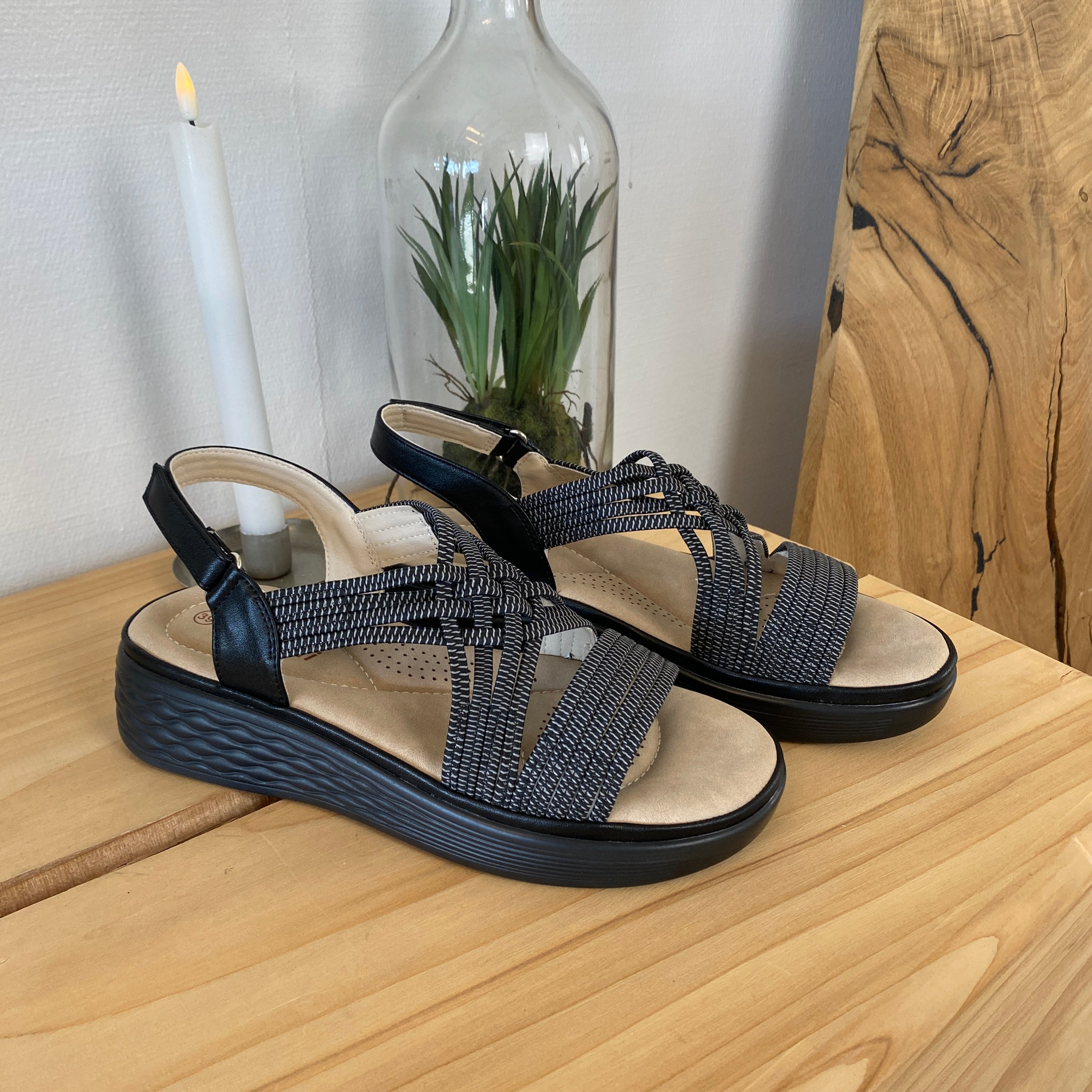 Sort sandal med elastiske remme og stødabsorberende sål